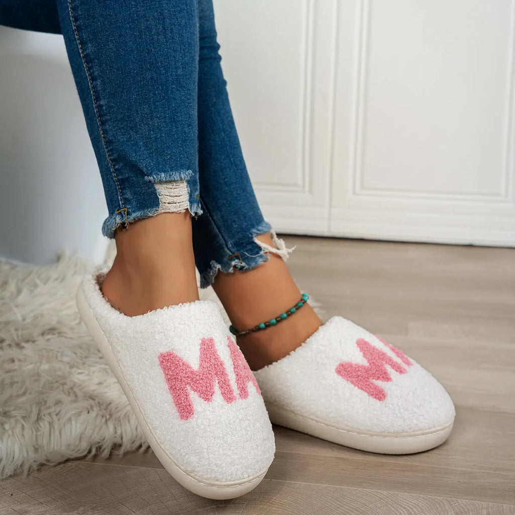 White plush cotton slippers with thick non-slip TPR sole on indoor floor