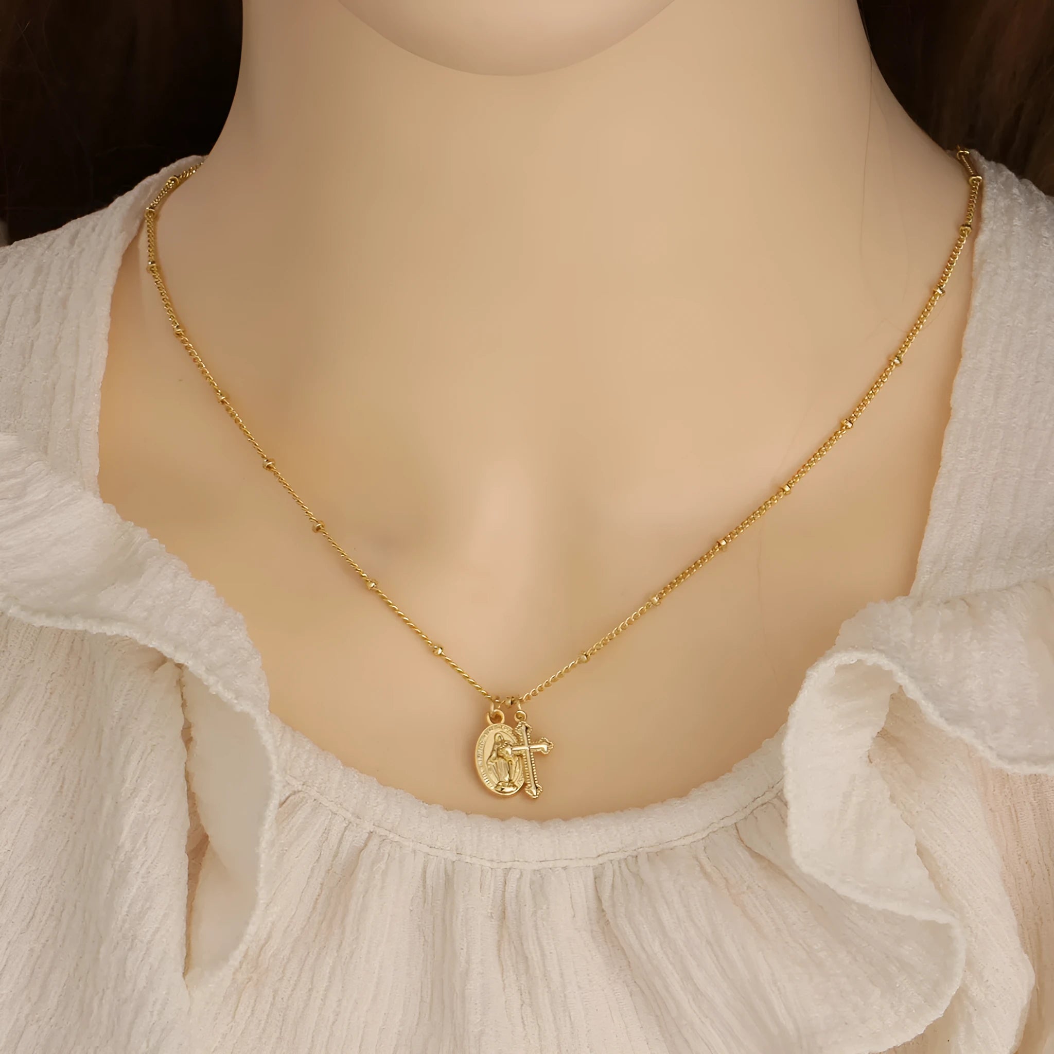 Geometric Virgin Mary cross pendant necklace in gold on a 45cm chain with lobster clasp.