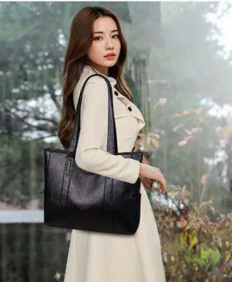 Soft PU horizontal square tote bag with double shoulder straps, black colour, sewing thread detail, and sandwich pocket