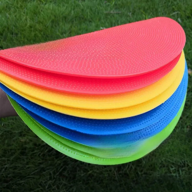 Yellow 23cm diameter flat TPE football training marker disc on grass