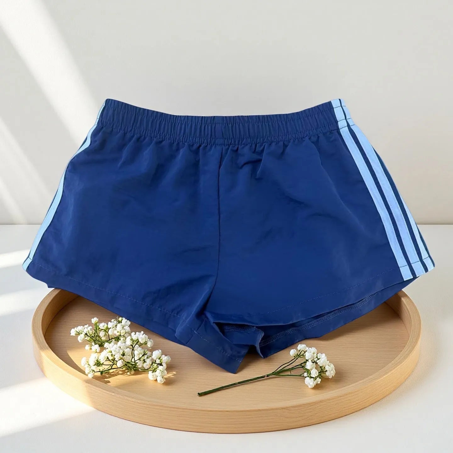 Men's navy blue high waist nylon sports shorts with micro elasticity on a white background