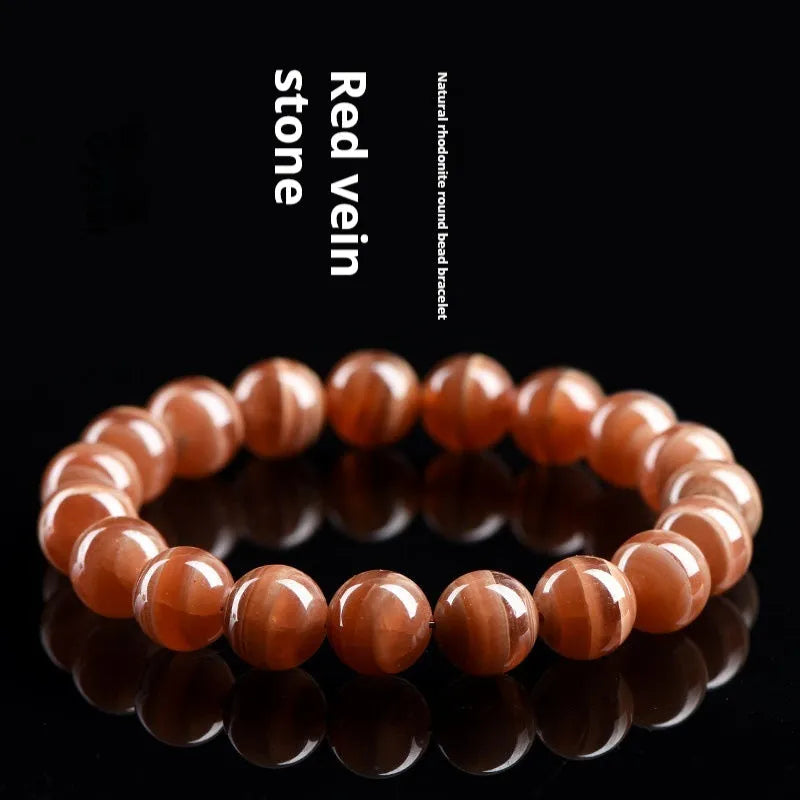 Natural Peruvian rhodochrosite bead bracelet in old mine colour, showing round 8mm beads.
