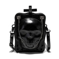 Black vertical square mini crossbody bag with embossed skull design, metal chain strap, and zipper closure