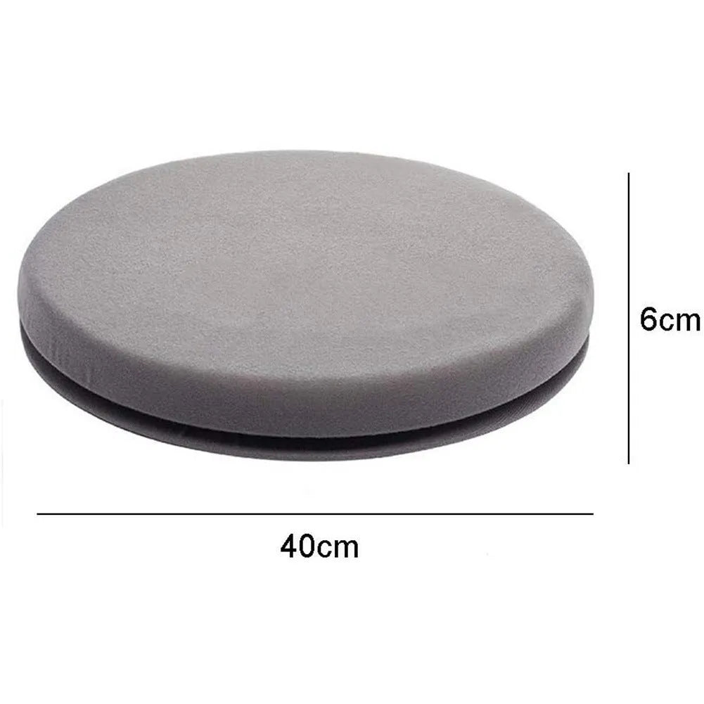 A grey rotating car seat cushion on a car seat, showing its non-slip base and plush fabric texture.