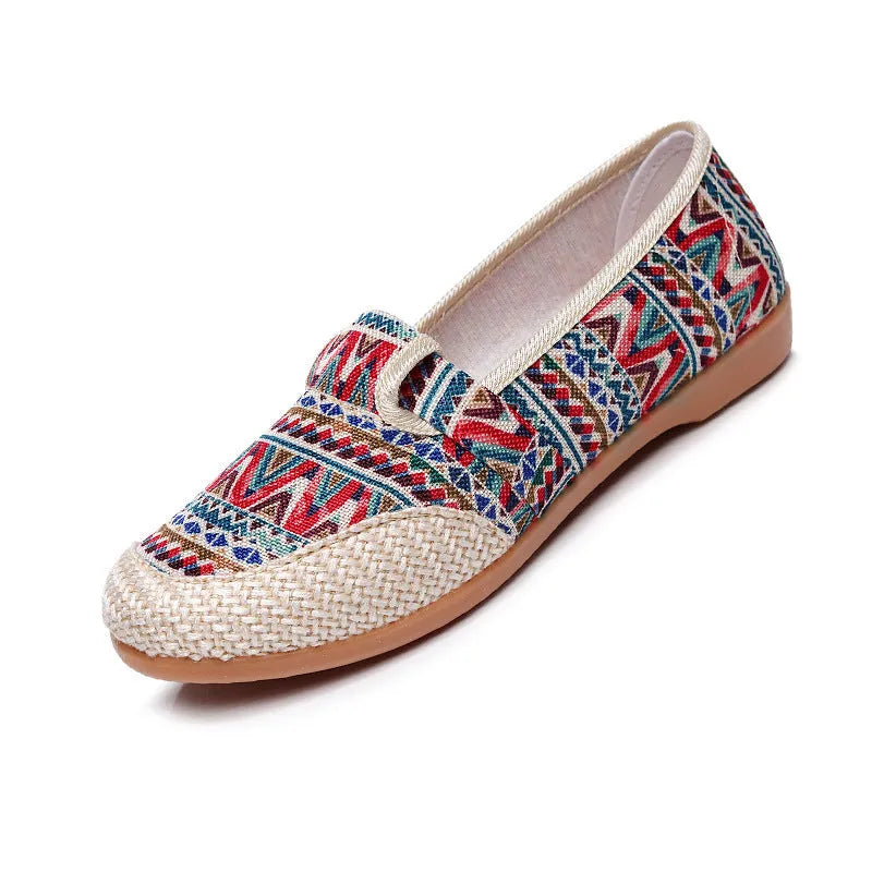 Women's ethnic style flat cloth shoes in red with colour stitching and a beef tendon sole.