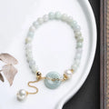 Natural emerald jade peace buckle bracelet with pearl accents and geometric pendant design
