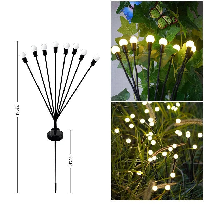 Solar-powered LED garden ground light with stainless steel spike, lit up in a lawn at dusk.