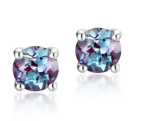 A pair of simple style silver ear studs with a round cultivated Alexandrite stone in a geometric setting.