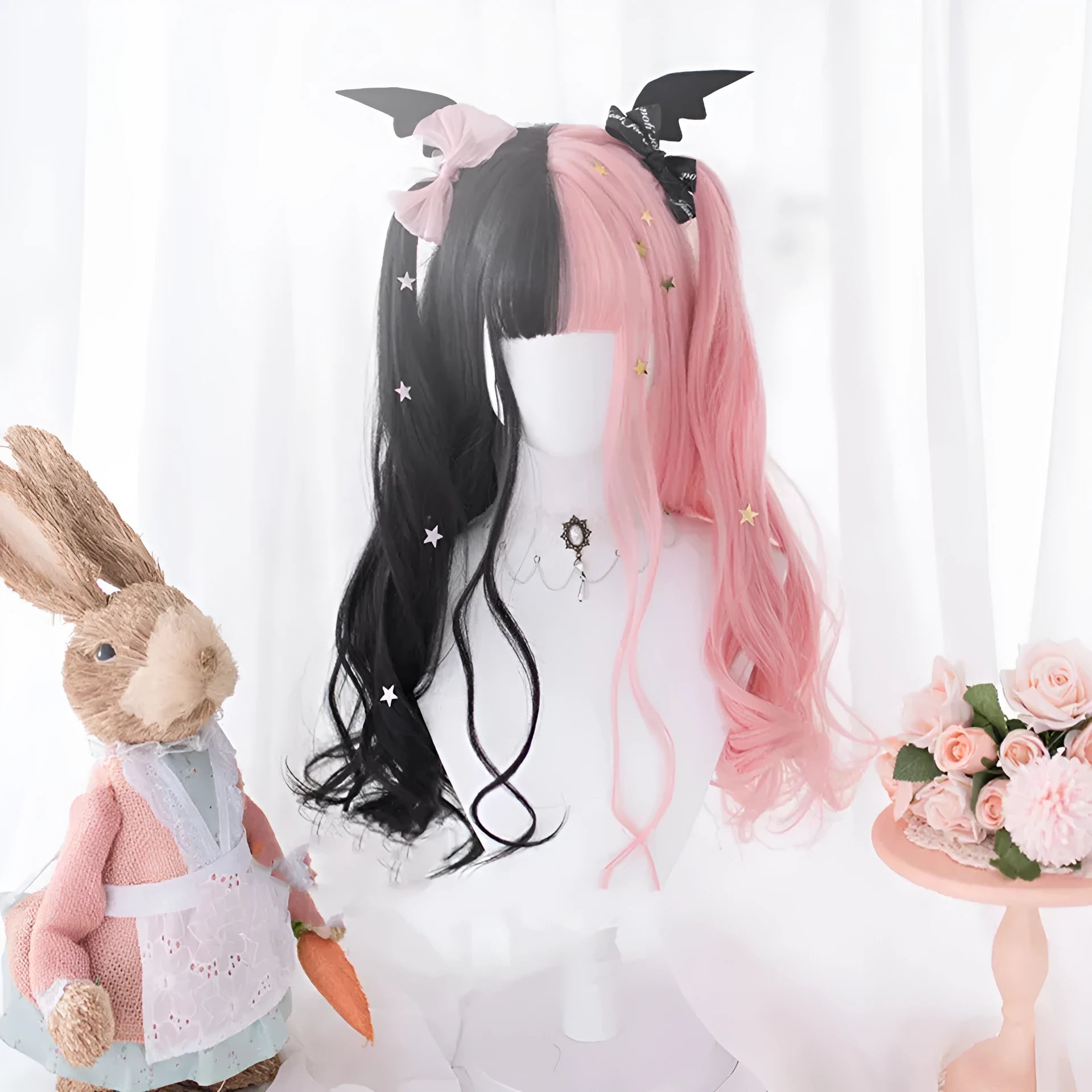 Harajuku Lolita long curly black and pink synthetic cosplay wig with bangs on a stand.