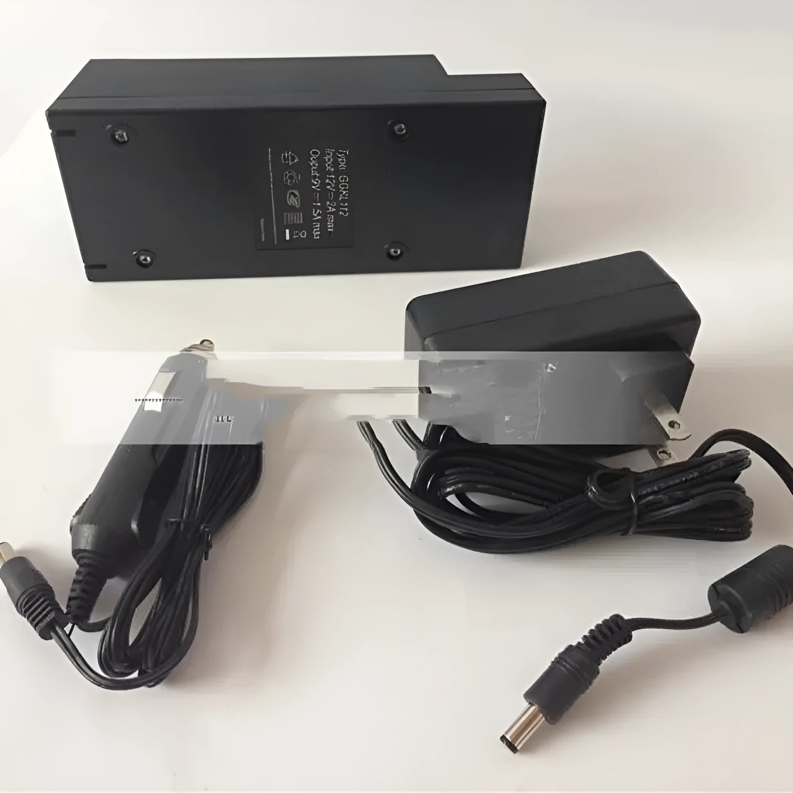 GKL112 compact white dual USB-A port car charger plugged into a vehicle's 12V socket.