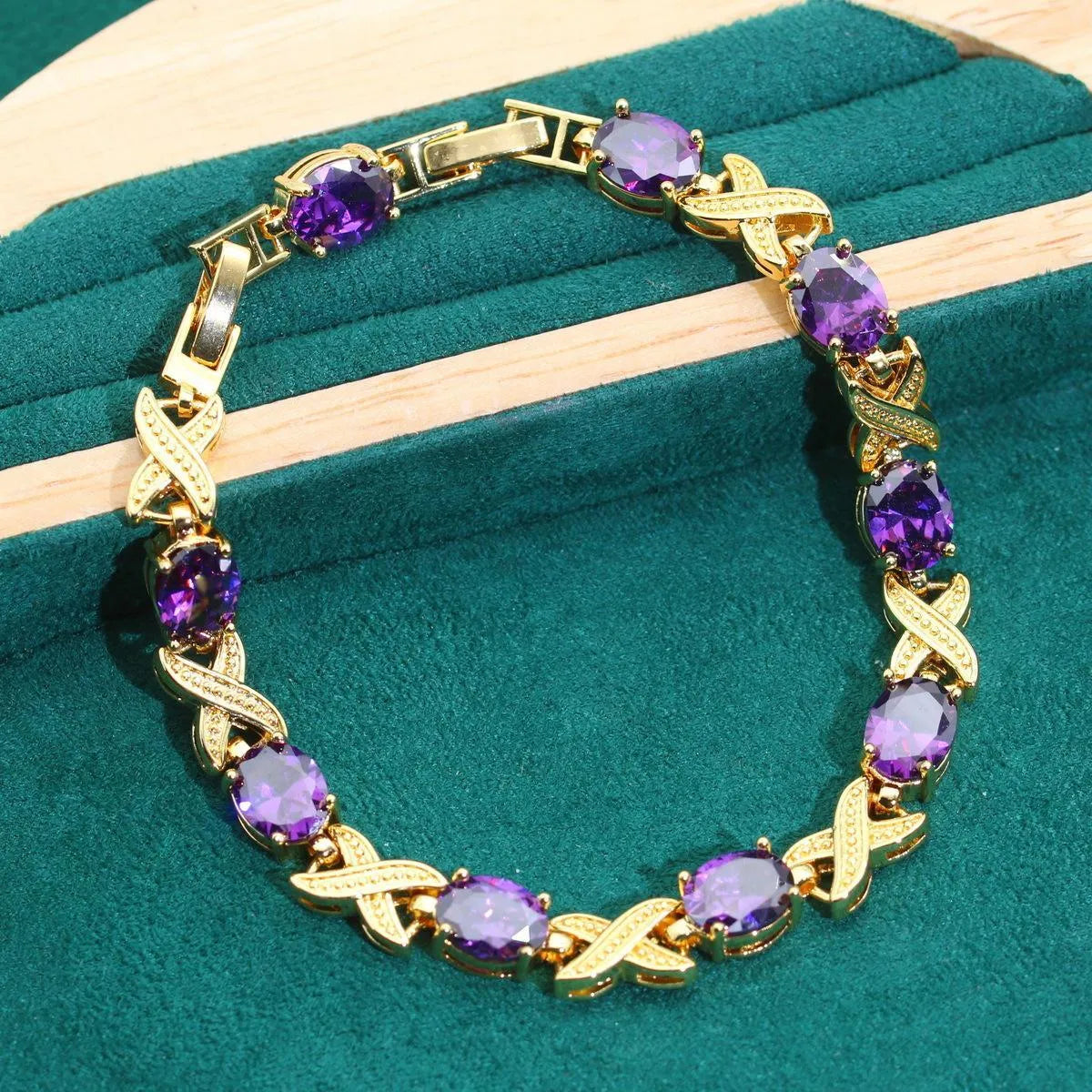 Gold plated jewellery set with colourful cubic zirconia stones, showing necklace, earrings, ring, and bracelet.