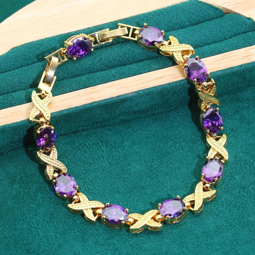 Gold plated jewellery set with colourful cubic zirconia stones, showing necklace, earrings, ring, and bracelet.