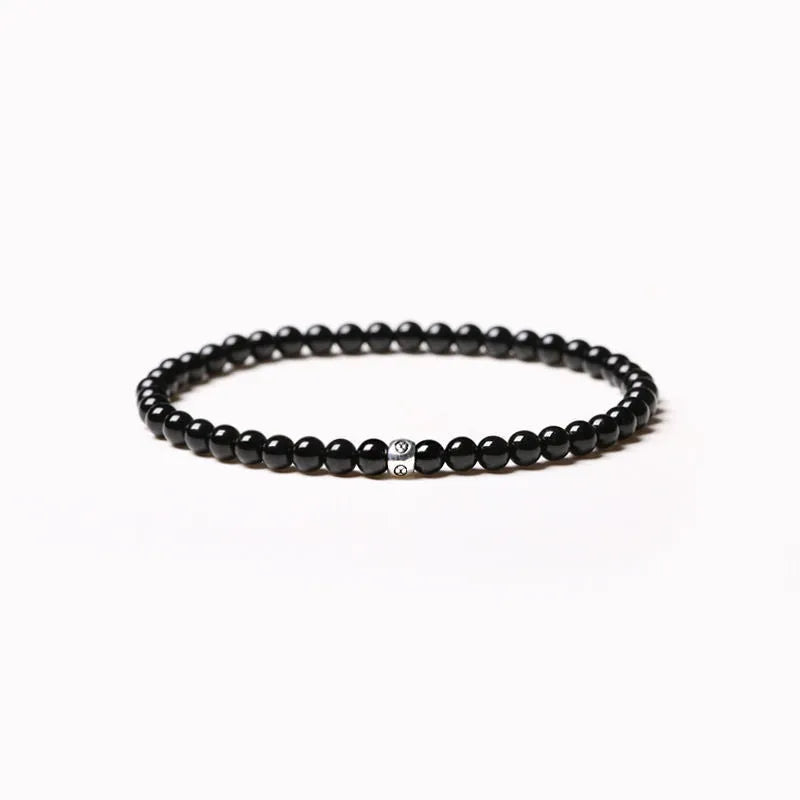 Geometric stone bead bracelet with black agate, blue san, obsidian, and cut surface black agate in chamfered square shapes