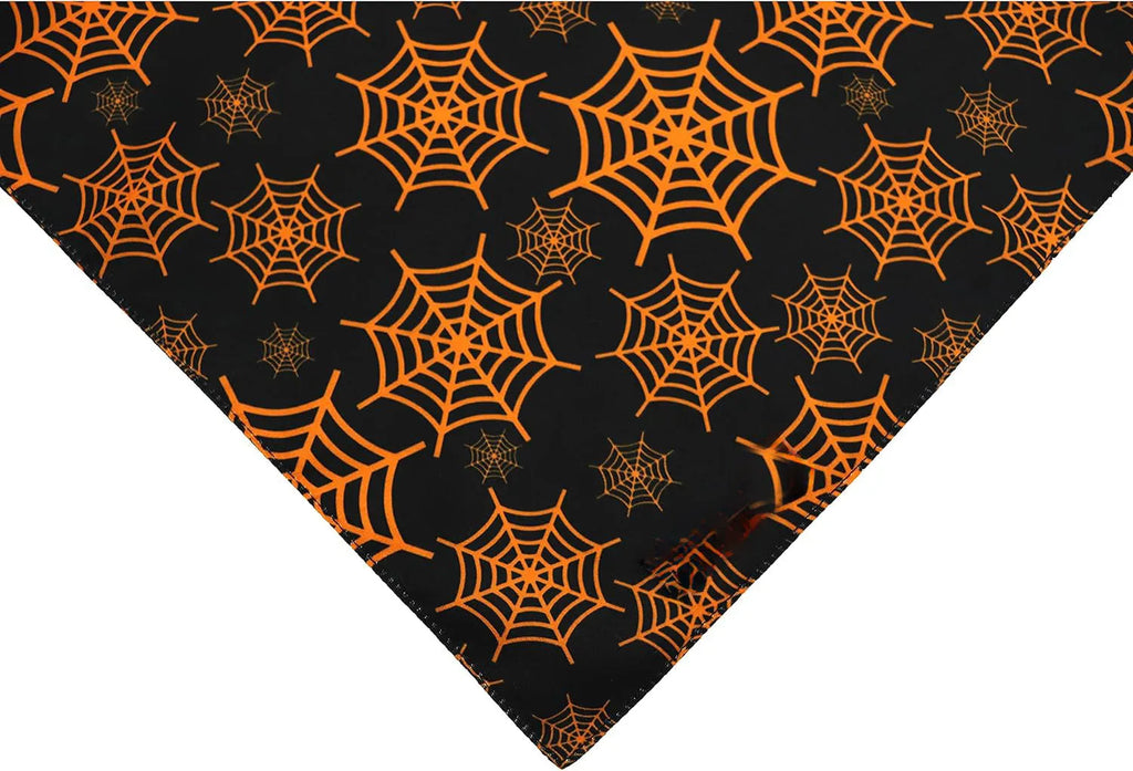 Reversible Halloween dog bandana with pumpkin and spider web patterns in black and orange