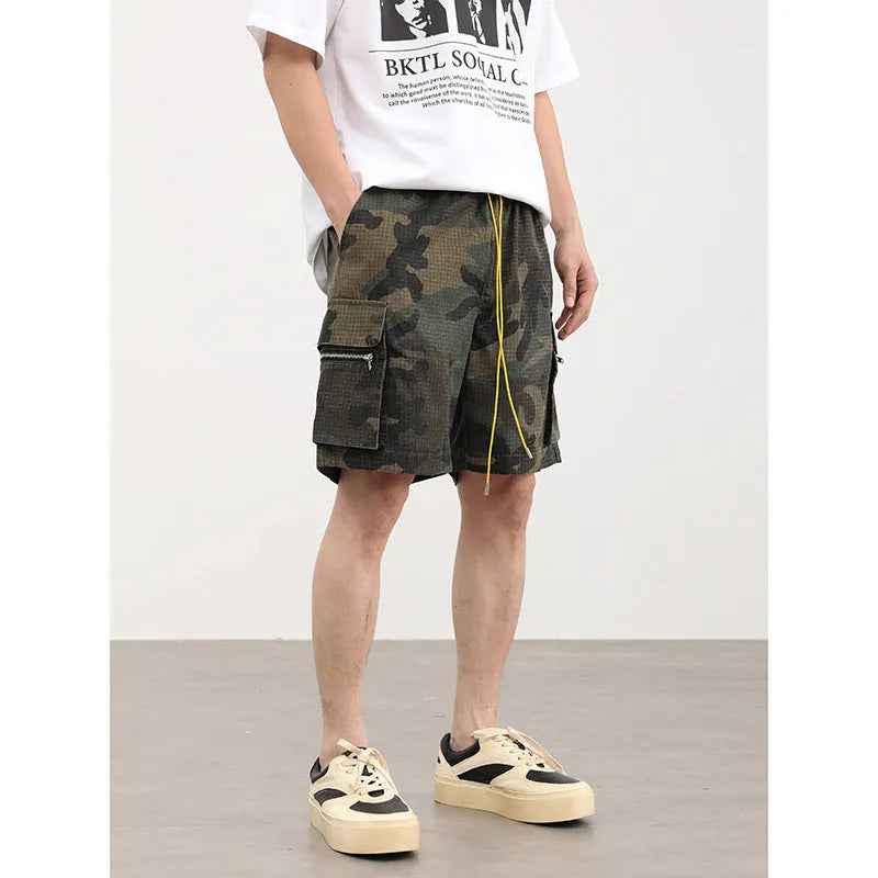 Men's camouflage work shorts with multiple pockets showing cropped length and mid-waist design