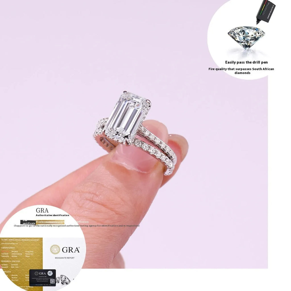 Pair of matching geometric S925 sterling silver rings with white finish on a flat surface