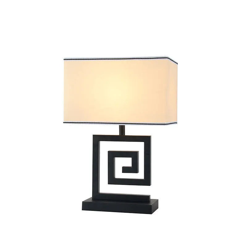 Retro style table lamp with fabric lampshade, iron frame, and remote control switch on a bedside table
