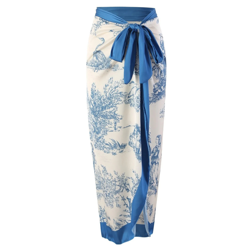 Blue patterned one-piece swimsuit for women on a mannequin, with an optional gauze skirt shown alongside.