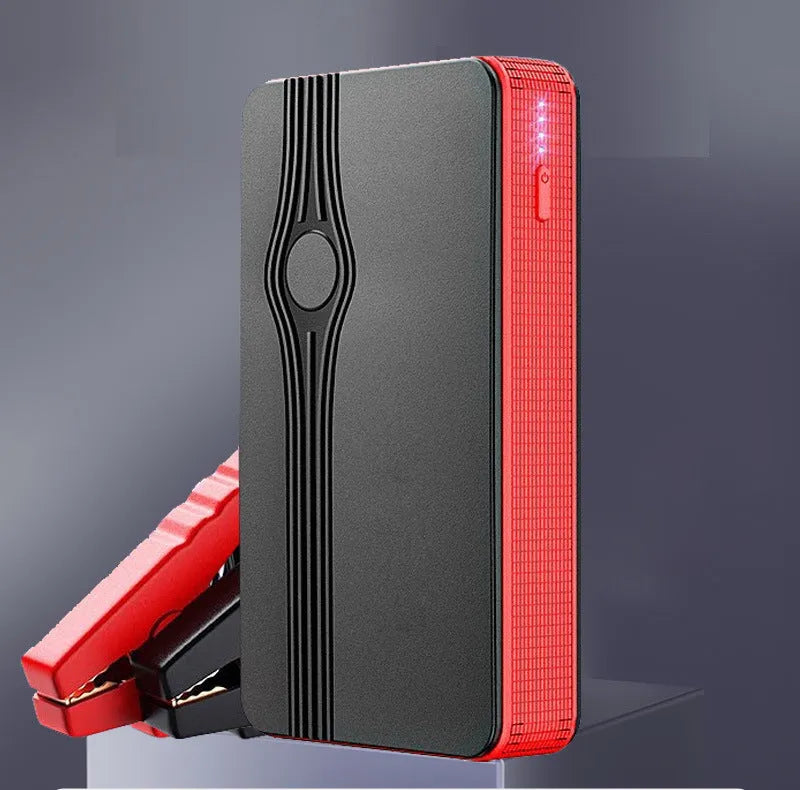 Red K4-E automotive emergency jump starter and power bank unit with charging cable.