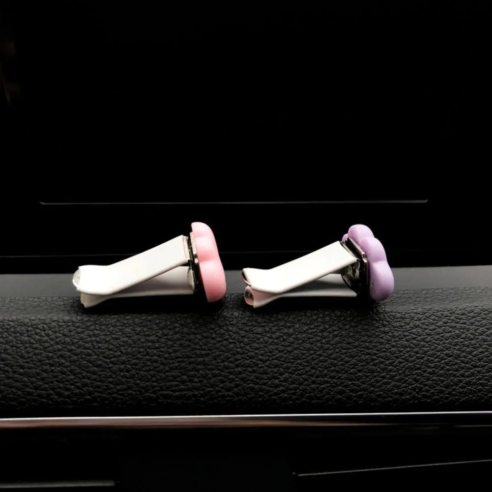 Resin Baiyun cartoon car air freshener clip in six colours on a car vent.
