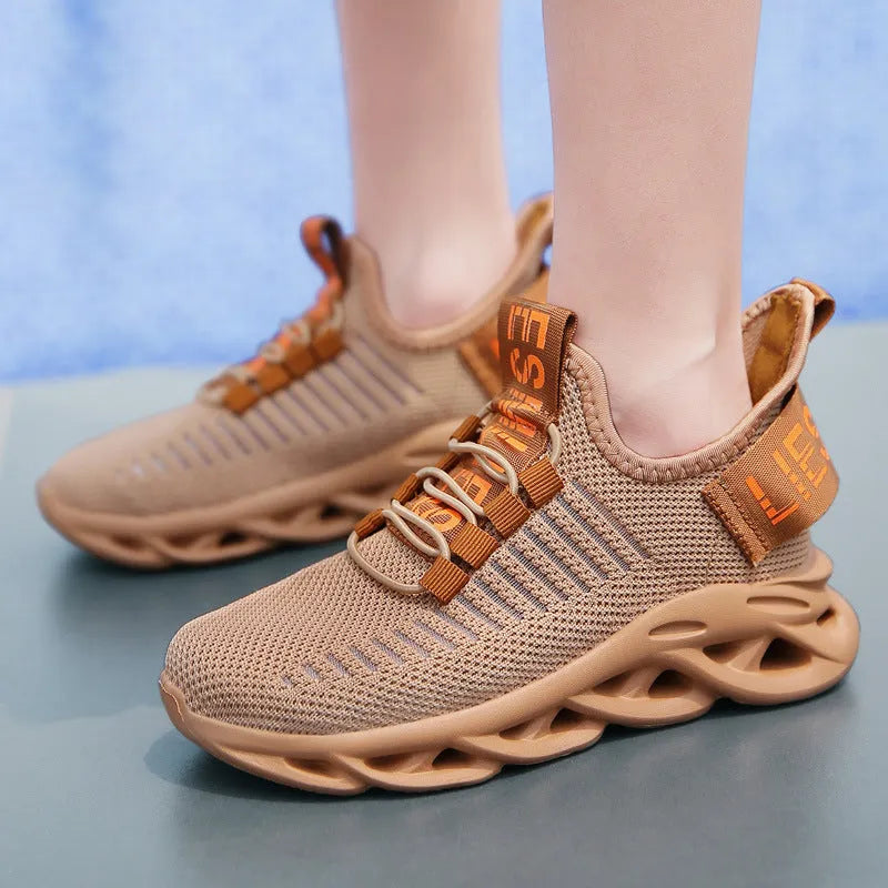 Kids black street-style sneakers with Velcro strap and textured EVA sole.