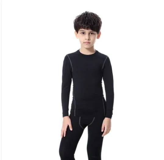 Children's sportswear set showing black and green T-shirts with shorts and trousers alongside size measurement chart