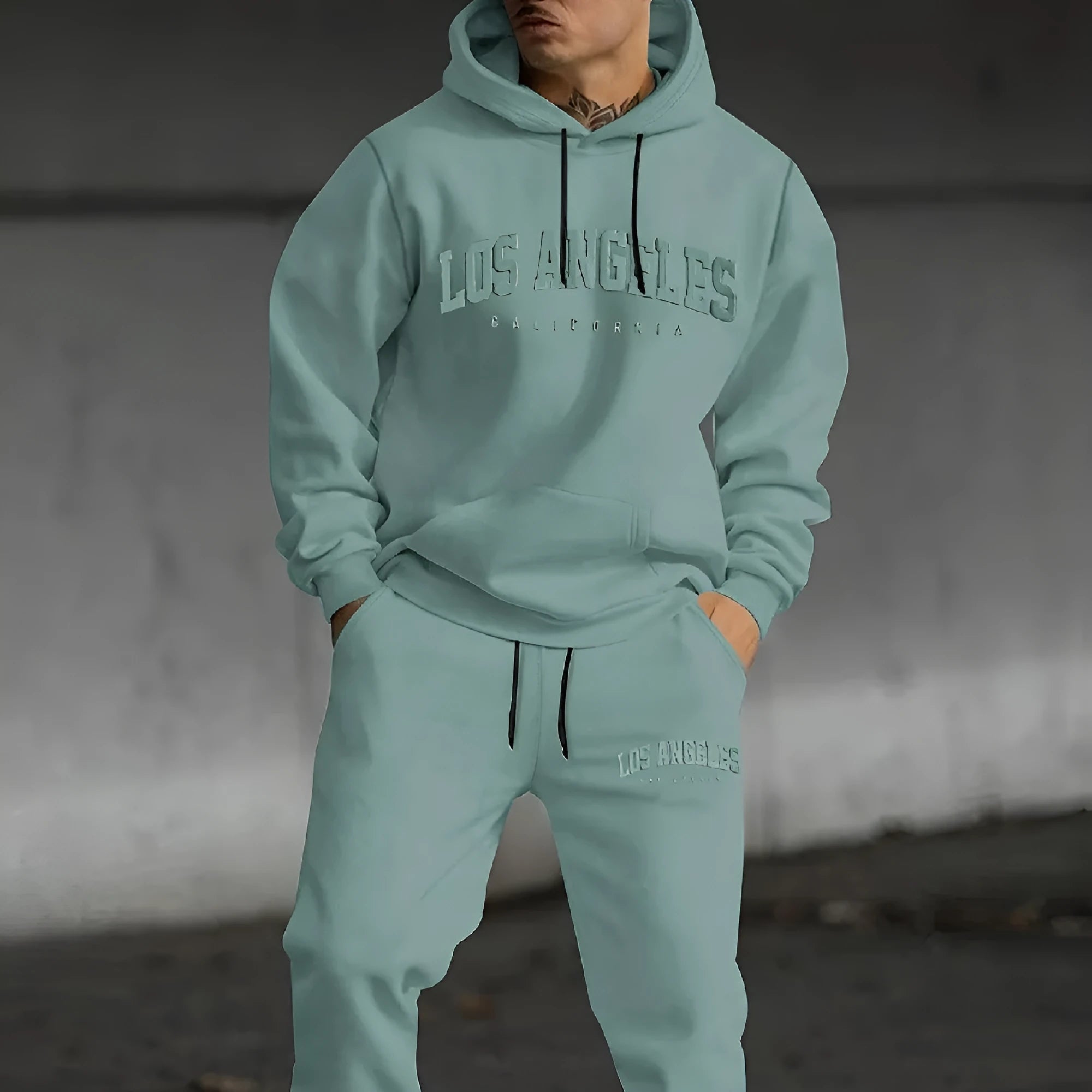 Men's loose-fit casual sweater suit with letter print in black, showing top and matching pants.