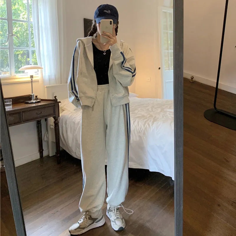 Women's two-piece striped polyester tracksuit set, light gray, top and trousers on plain background