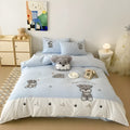 Cartoon Schnauzer design embroidered on a light blue cotton quilt cover and pillowcase.