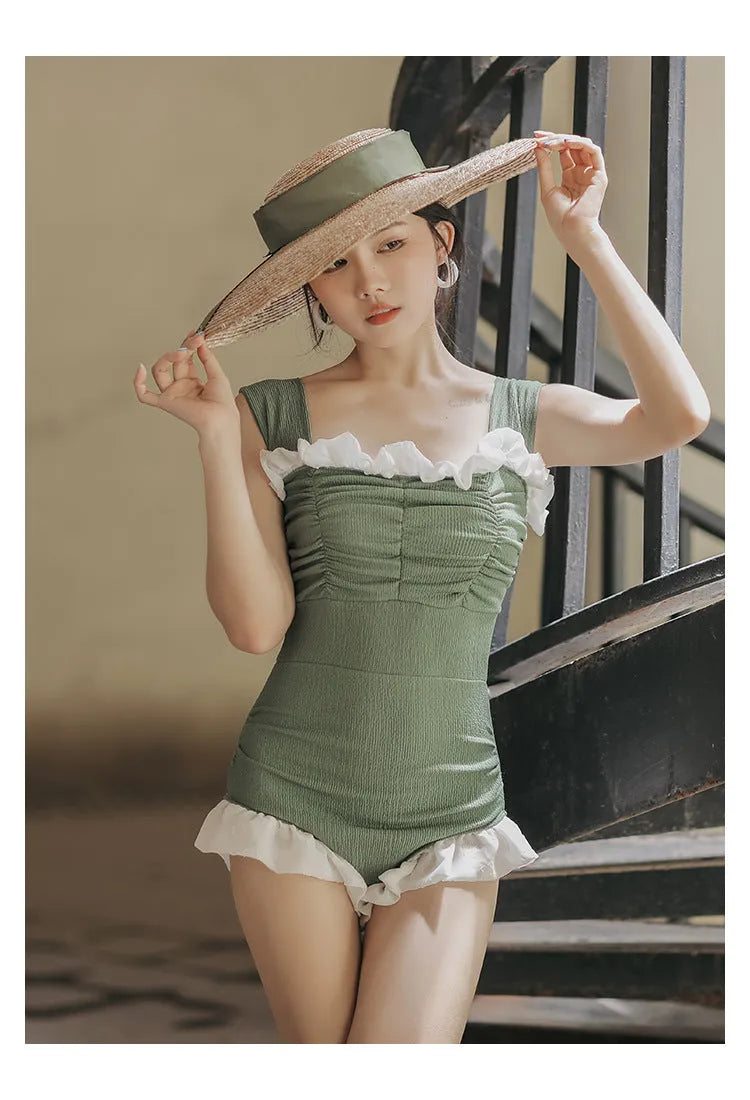 Black high-waisted one-piece swimsuit with triangle design on mannequin