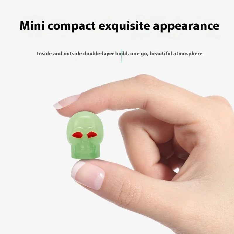 Luminous skull-shaped rubber car tyre valve cap in glow effect on a standard wheel