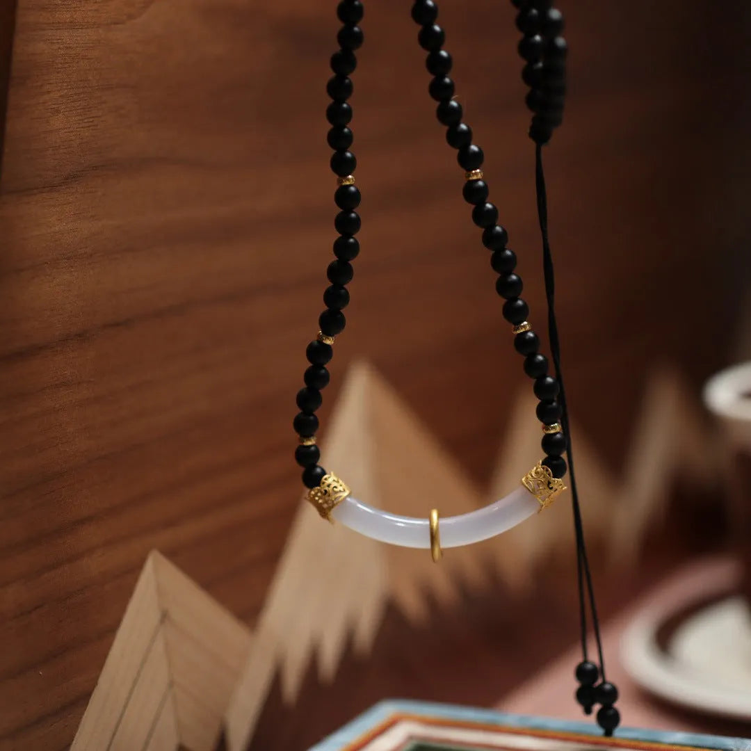 U-shaped Chinese style necklace with frosted black agate, white chalcedony, and 925 silver plating on a ball bead chain.