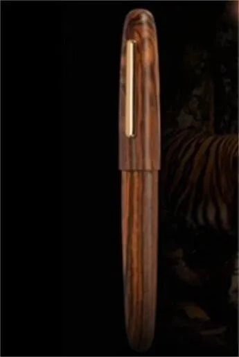 Wooden fountain pen with rotating cap showing grain detail and nib options