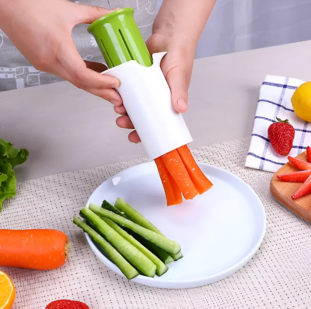 White handheld vegetable cutter with multiple stainless steel blades for slicing cucumbers, carrots, and strawberries.