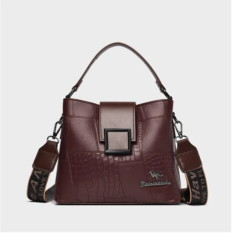 PU leather crossbody handbag with sewing line detail in brown, showing outer sandwich pocket and adjustable strap against neutral background