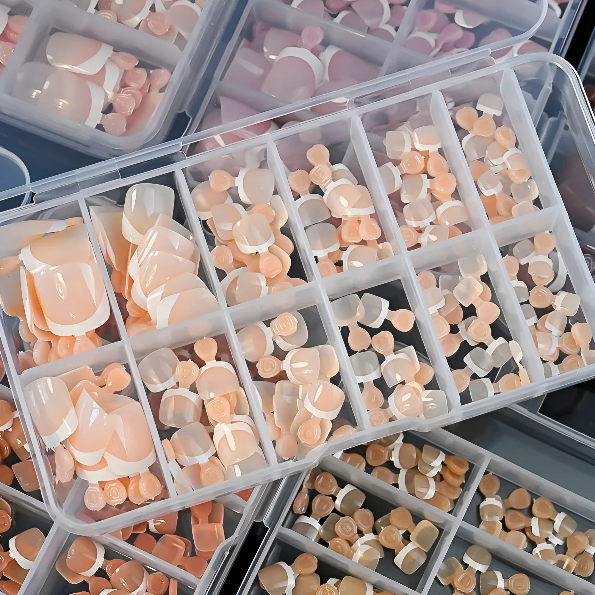 120-piece box of French white edge full square short acrylic nail tips in nine nude colours.