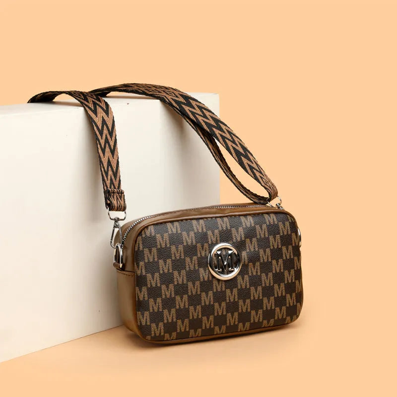 PU leather crossbody bag with wide strap showing three-dimensional front pocket in black colour