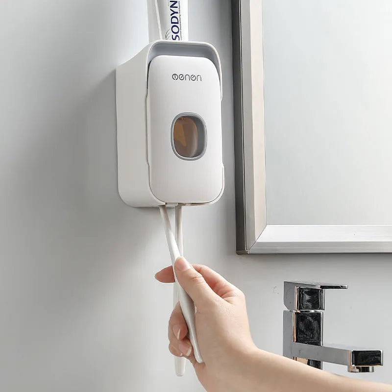 Blue automatic toothpaste dispenser mounted on a bathroom wall with motion sensor.