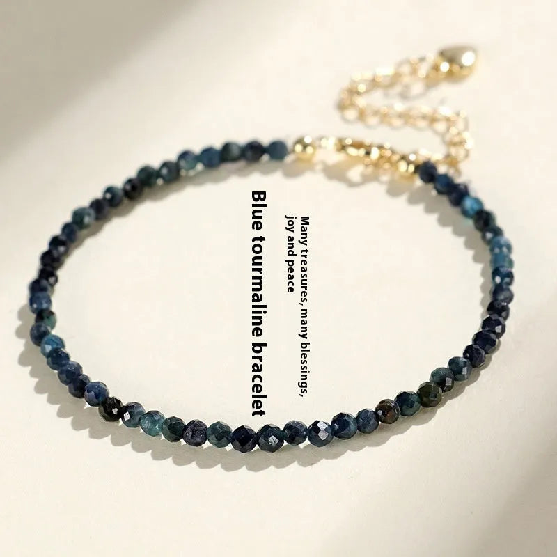 Blue tourmaline bracelet with 3mm beads and silver spacer beads on wrist