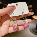Women's bowknot stud earrings with rhinestone detail in Blue Pink Red White, alloy electroplated, individually packed.