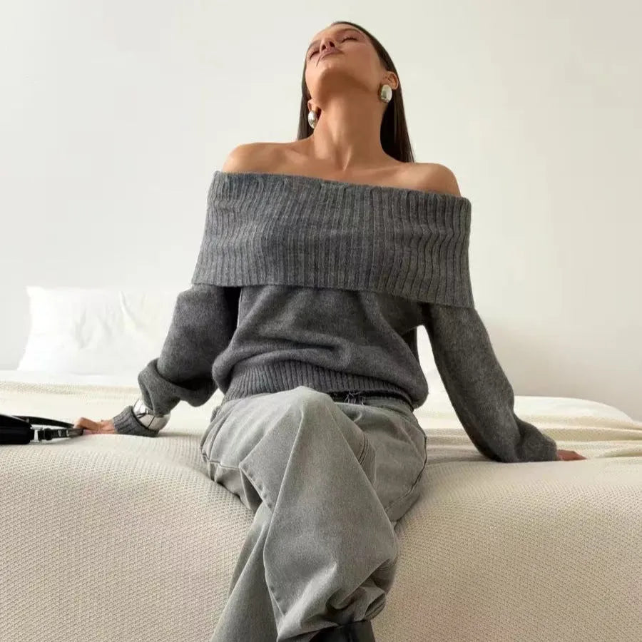 Grey off-the-shoulder sweater with a 3D pattern texture on the fabric.