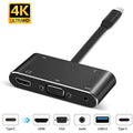 Black aluminium alloy 5-in-1 Type-C to HDMI and VGA adapter with USB and PD ports on a desk