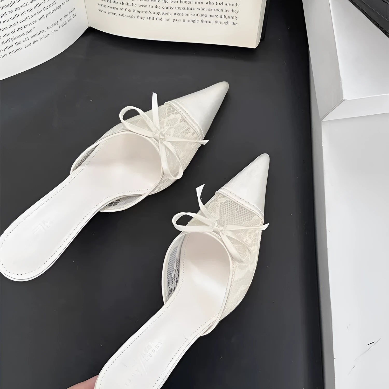 Women's light brown lace bowknot pointed toe high heels with mesh upper on a neutral background.