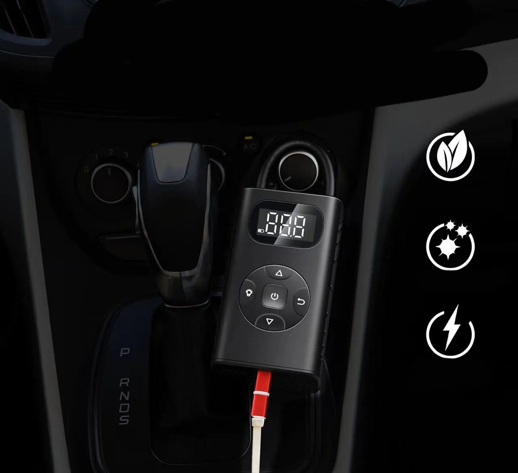 Black portable power bank tyre inflator with USB cable on a grey background.