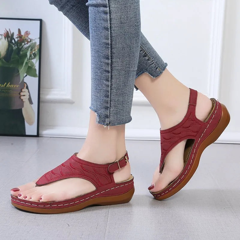 Women's casual wedge heel flip flop sandal in black with adjustable buckle strap.