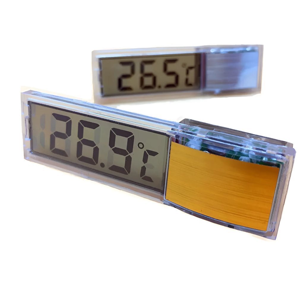 Gold digital stick-on aquarium thermometer on glass tank showing temperature reading