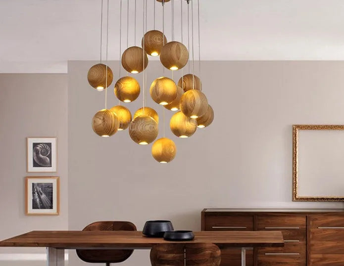 Nordic style solid wood ball chandelier hanging from ceiling with adjustable cord.