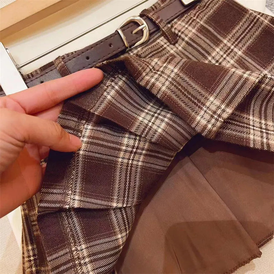 Children's plaid patterned pleated A-line skirt in cotton blend fabric.
