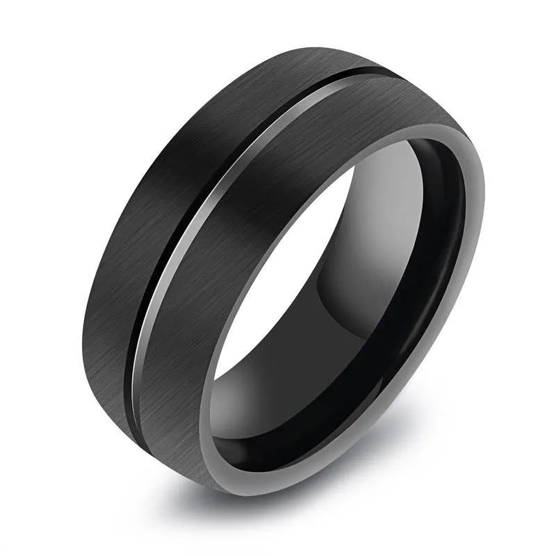 Black titanium steel ring with geometric design and alloy inlaid artificial stone on a dark background.