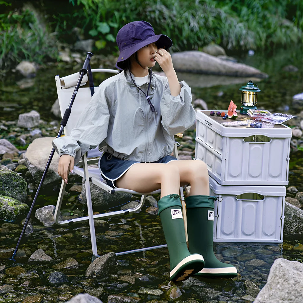 PVC waterproof high tube rain boots in beige, black, green, and red colours on a white background.